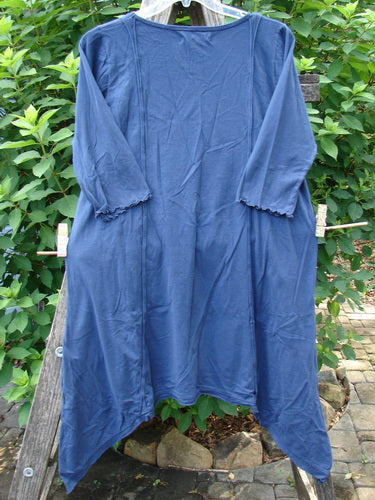 Barclay NWT Wildflower Tunic Star Pathway Dark Sky Size 0 on a clothesline, showcasing its unique raw-edged front panel, flutter hemline, and exterior drop front pockets. Perfect for expressing individual style.