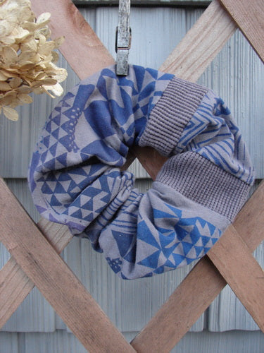 Barclay PMU Cotton Lycra & Thermal Hair Scrunchie Diamond Grid Brum Extra Large, styled ruffled with a thin elastic band, displayed on a wooden fence, showcasing its vintage-inspired, sustainable design.