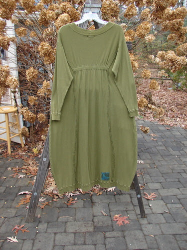 A Barclay Patched Thermal Curve Dress in Greenroot, size 1. Made from mid-weight cotton thermal, it features a unique figure-eight shape and curve, thicker rib neckline, and exterior stitchery. Double rib top exterior pockets, hem, and lower sleeves, with three sweet signature painted patches. Bust 50, waist 52, hips 54, length 50 inches.