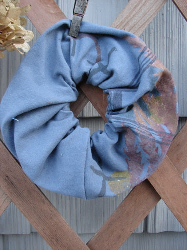 Barclay PMU Organic Cotton Hair Scrunchie Branch X Blue Dusk Extra Large, displayed on a wooden fence, showcasing its ruffled design with a clothespin, highlighting sustainable vintage-inspired craftsmanship.