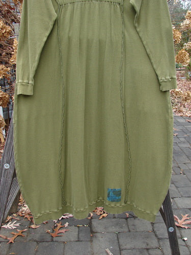 A Barclay Patched Thermal Curve Dress in Greenroot, Size 1. Made from Mid Weight Cotton Thermal. Features include a unique figure eight shape, thicker rib neckline, elastic upper back elastic tab, exterior stitchery, double rib top exterior pockets hem and lower sleeves, and three sweet signature painted patches. Measurements: Bust 50, Waist 52, Hips 54, Length 50 inches.