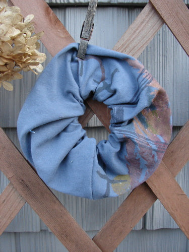 Barclay PMU Organic Cotton Hair Scrunchie Branch X Blue Dusk Extra Large displayed on a wooden fence, showcasing its ruffled texture and elastic interior, embodying Bluefishfinder.com's sustainable, vintage-inspired design ethos.