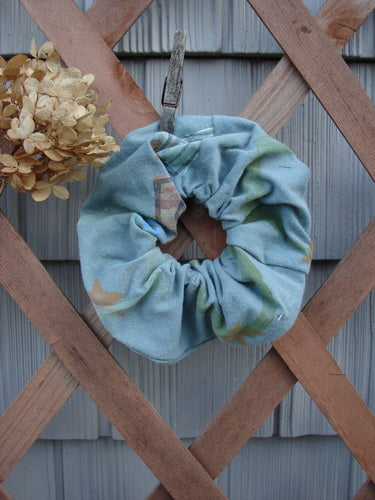 1996 PMU Organic Cotton Hair Scrunchie Abstract Mirror Extra Large displayed on a wooden fence, showcasing its ruffled design and soft texture, emblematic of Bluefishfinder.com's commitment to sustainable vintage fashion.