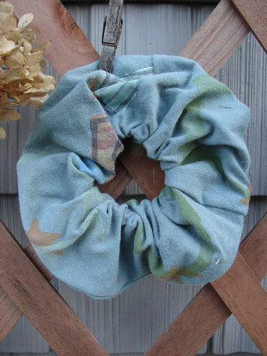 1996 PMU Organic Cotton Hair Scrunchie Abstract Mirror Extra Large displayed on a wooden fence, showcasing its ruffled fabric and thick organic cotton texture, embodying sustainable vintage design from Bluefishfinder.com.