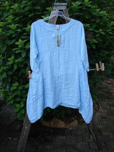Barclay NWT Linen Cross Over Urchin Pocket Dress Unpainted Splash Size 1 showcased on a wooden stand, highlighting its drop shoulders, smart V neckline, and double pockets, embodying BlueFishFinder's vintage creativity.