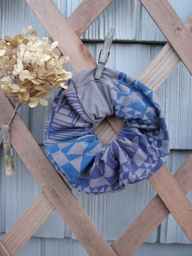 Barclay PMU Cotton & Lycra Hair Scrunchie Diamond Grid Brum Extra Large, featuring ruffled fabric and thin elastic, displayed on a wooden fence, highlighting its vintage-inspired sustainable design.