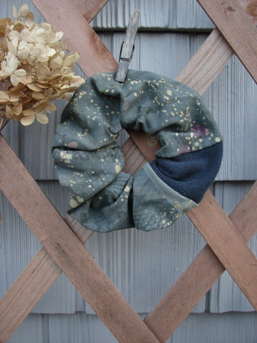 Barclay PMU Cotton Lycra & Thermal Hair Scrunchie Rain Pond Green Extra Large displayed on a wooden fence, showcasing its ruffled texture and elastic band, embodying Bluefishfinder.com's sustainable vintage design ethos.