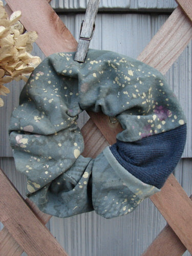 Barclay PMU Cotton Lycra & Thermal Hair Scrunchie Rain Pond Green Extra Large, displayed on a wooden surface with visible ruffled fabric and a thin elastic band, embodying vintage sustainability.