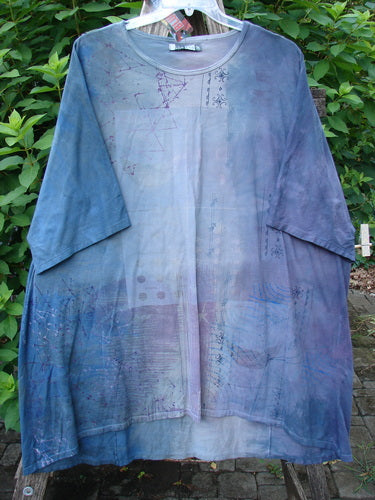 Barclay NWT Art Tee Celestial Mottled Purple Blues OSFA displayed on a rack, showcasing its tunic length, drop shoulders, loose three-quarter sleeves, and varying hemline in organic cotton.