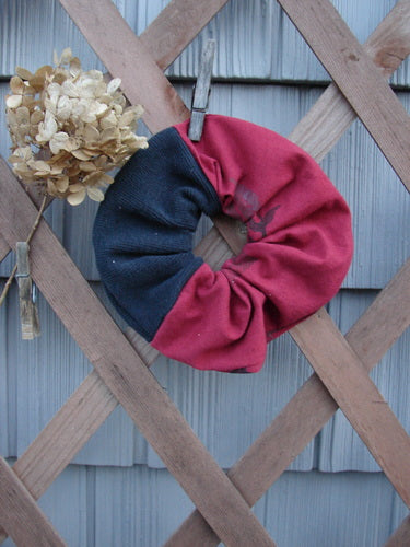 Barclay PMU Thermal Rib & Cotton Hair Scrunchie Vine Grid Black Red Extra Large, featuring a ruffled fabric design with a thin elastic band, displayed on a wooden lattice backdrop.