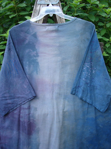 Barclay NWT Art Tee Celestial Mottled Purple Blues OSFA displayed on a rack, showcasing its tunic length, drop shoulders, loose three-quarter sleeves, and celestial-themed paint, representing Bluefishfinder.com's unique, expressive vintage style.