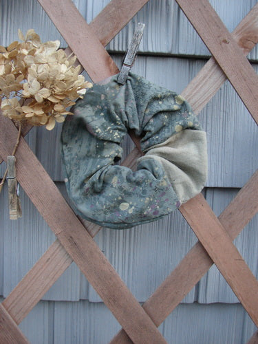 Barclay PMU Cotton & Lycra Hair Scrunchie Rain Pond Green Extra Large, featuring a ruffled fabric with thin elastic, displayed elegantly on a wooden fence.