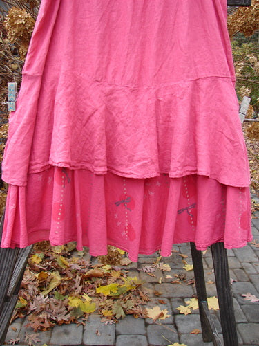 A Barclay Linen Two Tier Ruffle Skirt in Peony, featuring a painted batiste layer with a tiny dragonfly theme. Size 2.