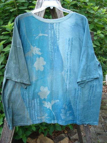 Barclay Center Seam Wide Line Tee Floral Path Mottled Turq OSFA featuring a blue shirt with white floral patterns, drop shoulders, and a boxy shape, highlighting organic cotton craftsmanship.