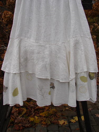 Barclay Linen Two Tier Ruffle Skirt: Medium weight white skirt with a patterned upper layer and a painted batiste lower layer. Features a wide double-lined fall and a huge lower batiste ruffle. Perfect for layering or wearing alone. Size 2.