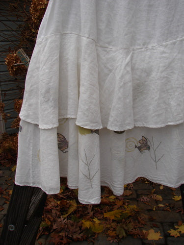 A white Barclay Linen Two Tier Ruffle Skirt with a tiny birdie design. Perfect for layering or wearing alone. Size 2.