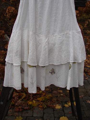 A white Barclay Linen Two Tier Ruffle Skirt with a huge lower batiste ruffle, perfect for layering or wearing alone. Size 2.