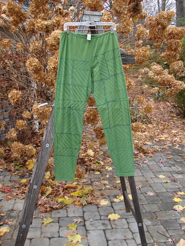 Barclay Cotton Lycra Slim Legging Continuous Pine Forest Size 2 on a wooden ladder, showcasing a unique pattern.