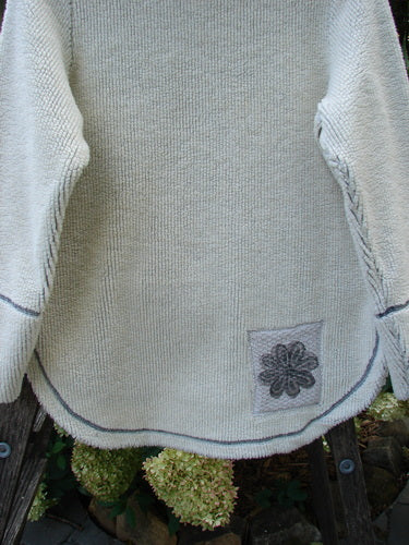 Close-up of the 2000 PMU Fleece Pullover High Back Chair Natural Size 0, showcasing its heavy-weight poly fleece material, added front and rear patches, rounded hemline, and kangaroo pocket.