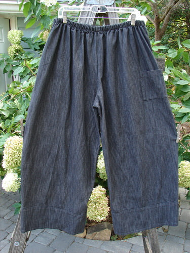 Barclay NWT Perspective Pant Unpainted Black Striation Size 1 hanging on a tree, showcasing its full back elastic waistline, side ties, wide legs, and rear pocket in a textured denim.