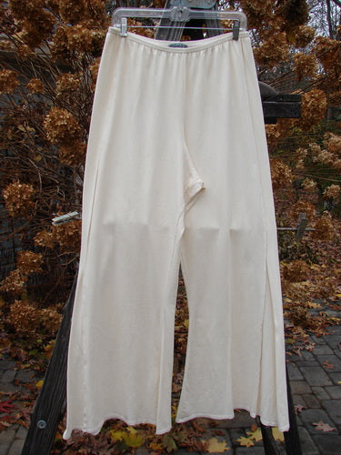 Barclay Cotton Lycra Triangle Pant on Clothes Rack - Cream, Size 2 AI. Full elastic waist, narrowing at knee, widening into belled lowers. Triangular inserts, unpainted. Waist 30-40, Hips 52, Inseam 30, Length 42.