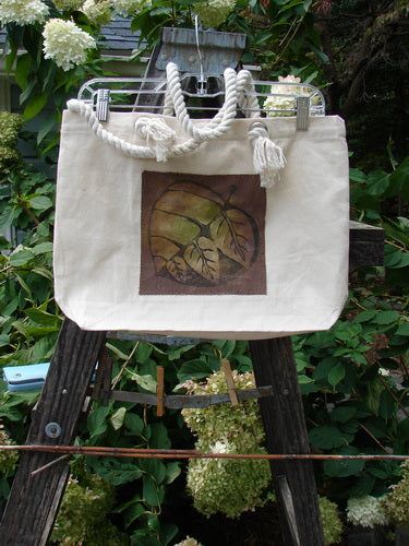 1998 PMU Patched Canvas Rope Tote Bag Hydrangea Leaf Natural OSFA, featuring a brown leaf design on heavy-weight cotton canvas with rope shoulder straps, gusset bottom, and interior pocket.