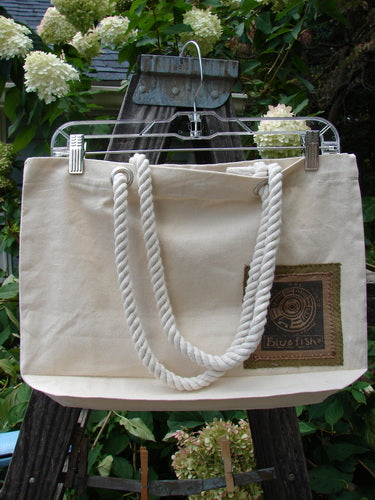 1998 PMU Patched Canvas Rope Tote Bag Hydranga Leaf Natural OSFA featuring a white tote with cotton rope shoulder straps, interior snap, gusset bottom, and Blue Fish Patch adorned with hydrangea leaf design.