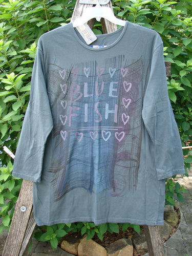 Barclay NWT Long Sleeved Studio Tee Blue Fish Love Thoreau Size 0 features a straighter shape, long sleeves, and a rounded neckline, highlighting the classic Blue Fish Love theme in organic cotton.