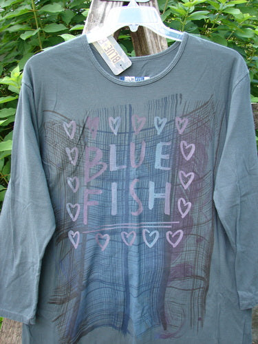 Barclay NWT Long Sleeved Studio Tee Blue Fish Love Thoreau Size 0, featuring a straighter shape, cozy long sleeves, and a rounded neckline, displayed on a clothes rack.