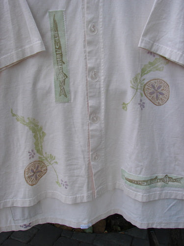 Close-up of the 1997 PMU Patched Island Beach Jacket Alligator Powder OSFA, showcasing oversized textured buttons, sea life-themed paint, and alligator patches with a unique hemline and vented sides.