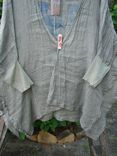 Barclay NWT Linen Open Front Cheerful Crinkle Cardigan in Caper, featuring dolman sleeves, ribbed cuffs, and a floral blossom theme, highlighting its unique vented hemline and open-front design.