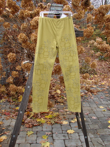 A pair of Barclay NWT Cotton Lycra relaxed leggings with a star path design on a wooden rack.