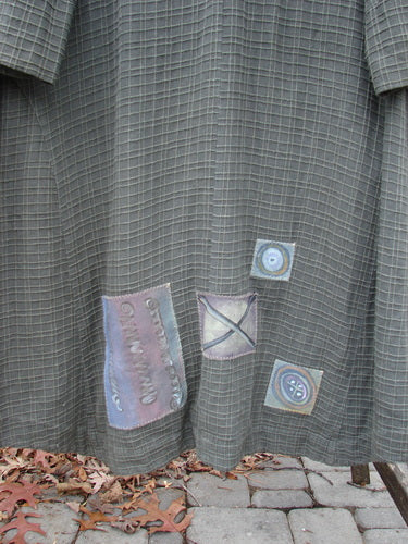 2001 Patched Toy Box Jacket, a close-up of a coat with raised cording patterns, vintage button closure, oversized front pockets, and colorful patches.