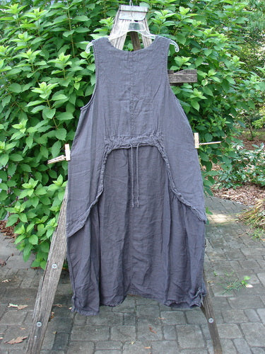 Barclay NWT Linen Explorer Jumper Contour Garden Black Sand Size 0 displayed on a wooden ladder, showcasing a scoop neckline, generous pocket, and detailed overlay full bodice with unique garden-themed paint accents.