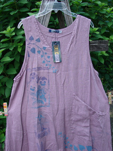 Barclay NWT Linen Explorer Jumper Contour Pansy Patch Tulsi Rose Size 0 displayed on a wooden rack, showcasing its scoop neckline, generous upper pocket, and full A-line shape with decorative pansy theme.