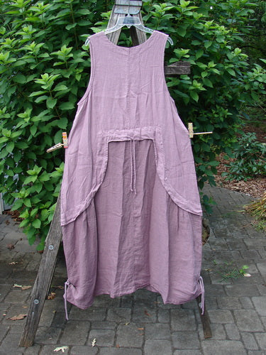 Barclay NWT Linen Explorer Jumper Contour Pansy Patch Tulsi Rose Size 0 displayed outdoors, showcasing its unique scoop neckline, overlay full bodice, and billowy lower sweep with pansy theme paint details.