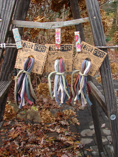 A group of colorful ties on a wooden ladder, perfect for jazzing up your Fish! New TRIPLE Rippie Packs One Size.