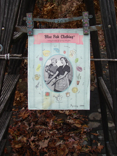 A poster on a ladder featuring the 1999 Spring 1 Catalog Kitchen Delights. Rediscover vintage Blue Fish Clothing by Jennifer Barclay.