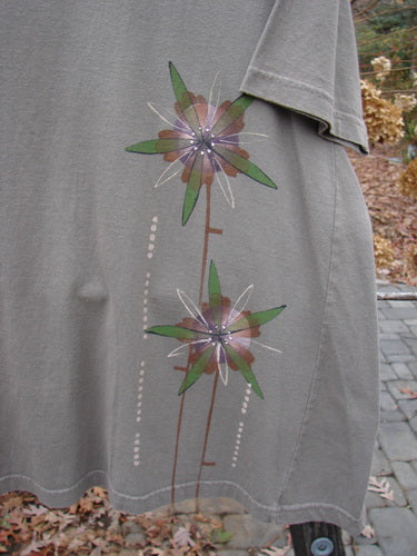 Barclay Short Sleeved A Line Top Lolly Daisy Storm Grey Size 0: A close-up of a flower design on a grey shirt.