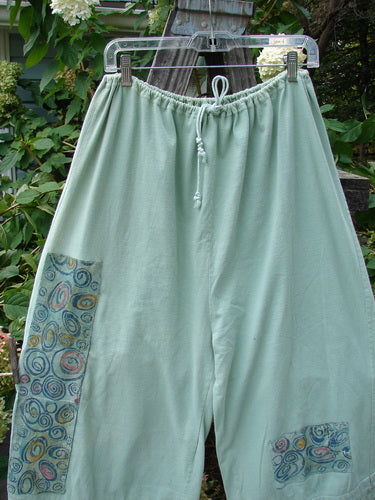 1992 PMU Patched Pantaloon Continuous Spin Cucumber OSFA hanging on a clothesline, showcasing a drawcord waistline, wide lowers with antique lace, and signature patches, reflecting vintage Blue Fish Clothing style.