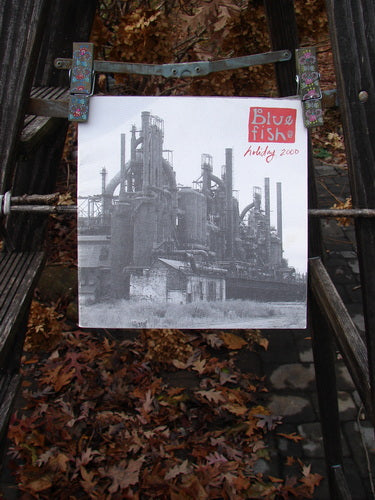 A black and white picture of a factory on a metal stand, featured in the 2000 Holiday Catalog Freedom of Expression.