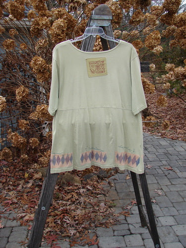 Image alt text: "1993 3 Square Dress with Trinket Diamond Patch on a white shirt, featuring a unique design with sectional panels and a slight empire waist seam. Perfect for serious collectors of vintage Blue Fish Clothing."