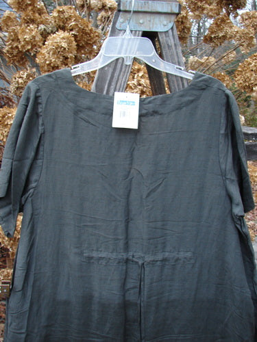 2000 NWT Hemp Silk V Over Top Biology Domino Size 1, featuring a deep V-neckline and flowy A-line shape, displayed with a tag on a hanger against dried foliage, showcasing its crinkled texture.