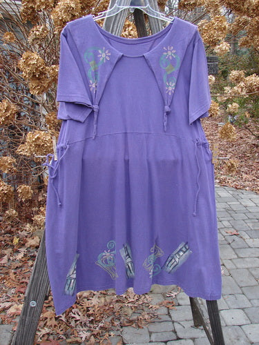1994 Elfin Dress Mixed Theme Purple Nuit Size 2: A playful purple dress with a floral design, featuring a dramatic collar, sailor-like rear collar, and adjustable waistline. A rare and unique piece from the Transitional Collection of 1994.