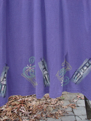 A purple curtain with a picture of a lamp and a drawing of a tie.