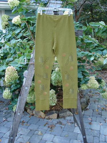 2000 Thermal Layering Lu Pant Soft Geo Greenroot Size 1 displayed on a wooden ladder, showcasing its ribbed lowers and pocketless hip design, emphasizing Bluefishfinder.com's vintage Blue Fish Clothing style.