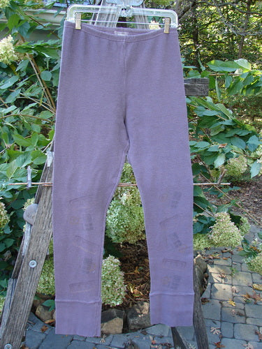 2000 Thermal Layering Lu Pant Soft Geos Eggplant Size 1, displayed hanging outdoors, showcasing its nifty ribbed lowers and pocketless hip design, part of Bluefishfinder.com's vintage collection.