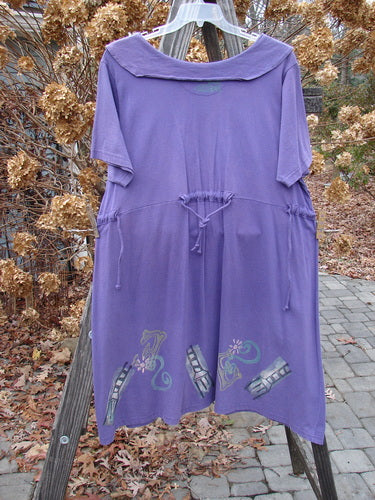 1994 Elfin Dress in Purple Nuit, Size 2. A rare piece from the Transitional Collection. Dramatic collar, sailor-like rear collar, slight A-line shape, adjustable waistline, widening hemline, empire waist seam. Bust 52, waist 52-54, hips 52-54, sweep 80, length 39.