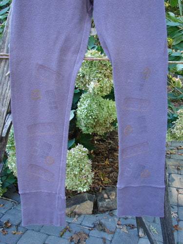 2000 Thermal Layering Lu Pant Soft Geo Eggplant Size 1 hanging on a clothesline, showcasing its ribbed lowers and pocketless hip, part of the Blue Fish Clothing Winter Collection.