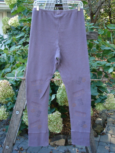 2000 Thermal Layering Lu Pant Soft Geo Eggplant Size 1 hanging on a clothesline, featuring ribbed lowers and a replaced elastic waistband, exemplifying BlueFishFinder.com's vintage style.